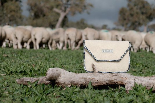 Wool Laptop Bag, Wool Document Bag, Bag in a Sheep Paddock with sheep grazing in the background